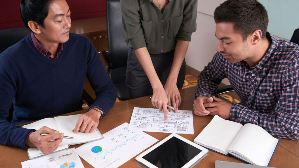 "Business team analyzing financial charts and diagrams during strategic planning meeting"